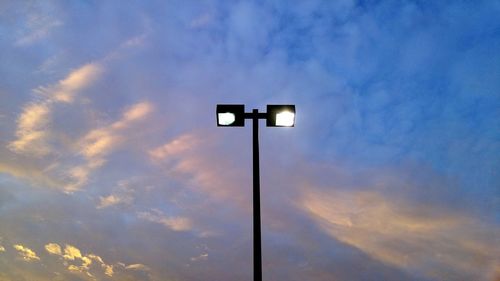 Low angle view of street light against cloudy sky