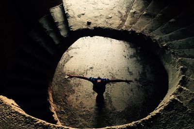 High angle view of man standing in tunnel