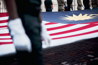 Low section of man holding american flag