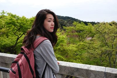 Portrait of beautiful young woman looking away