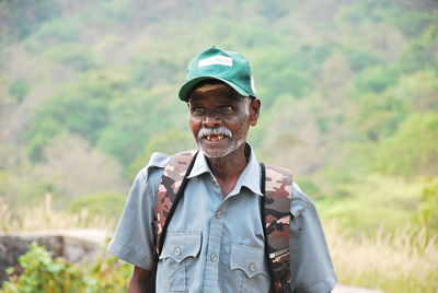 Portrait of smiling man standing outdoors