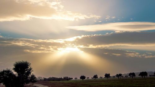 Scenic view of landscape against sky at sunset