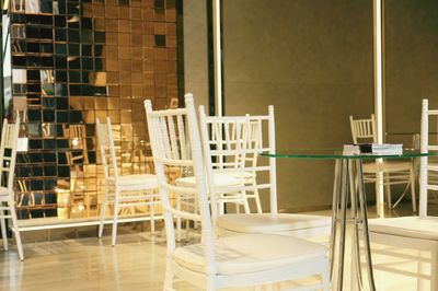 Empty chairs and tables in building