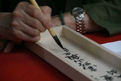 Close-up of man writing