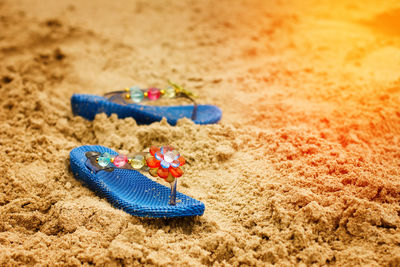 Close-up of shoes on sand