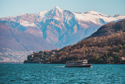 Scenic view of sea and mountains against sky