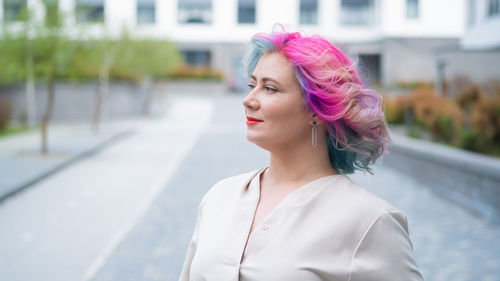 Portrait of beautiful young woman standing outdoors