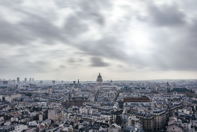 Cityscape against cloudy sky