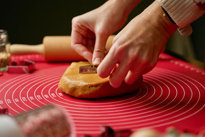 Cropped hand of man holding coins on table