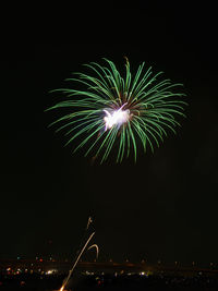 Low angle view of firework display at night