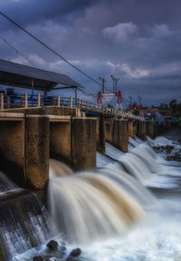 Scenic view of river flowing against sky