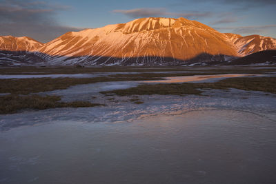 Scenic view of snowcapped mountains against sky