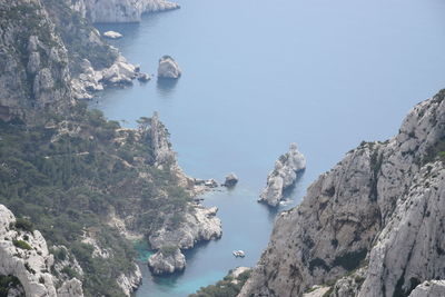 High angle view of rocks on sea shore