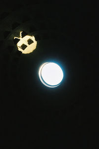 Low angle view of illuminated lights at night