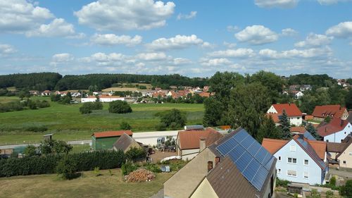 High angle view of houses and trees against sky