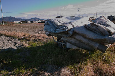 Abandoned truck on field against sky