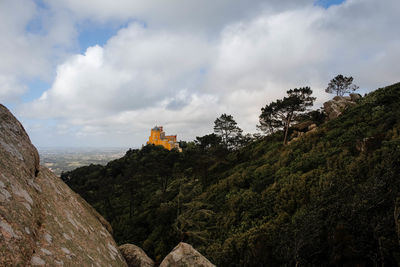 Panoramic view of trees and buildings against sky