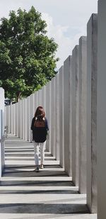 Rear view of woman standing on walkway