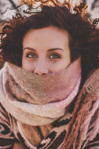 Portrait of young woman in warm clothing outdoors