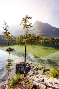 Scenic view of lake by mountain against sky