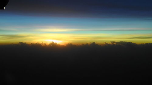 Silhouette trees against sky during sunset