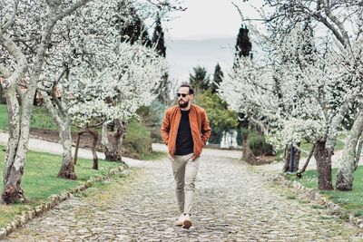 Portrait of man wearing sunglasses against trees