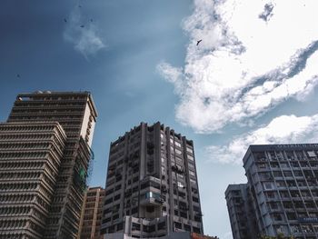 Low angle view of buildings against sky in city