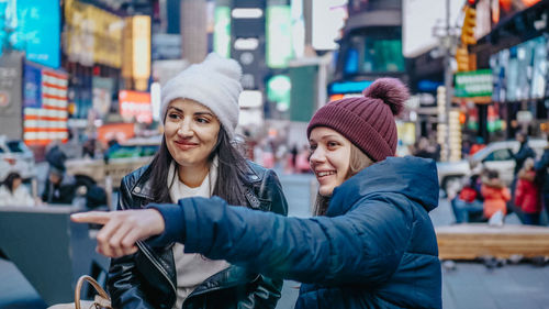 Portrait of smiling young woman in city