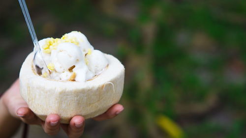 Close-up of hand holding ice cream