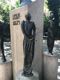 Statue against trees