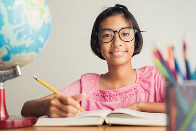 Portrait of a smiling young woman reading book