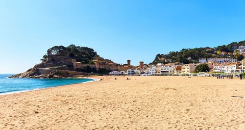 Scenic view of beach against clear blue sky at tossa de mar