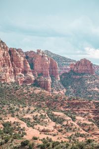 Rock formations on landscape against sky