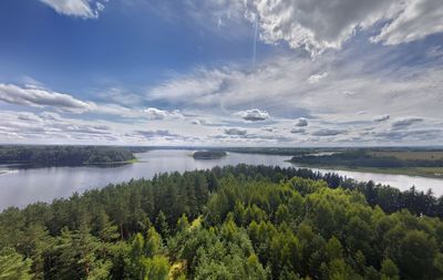Scenic view of green landscape against cloudy sky