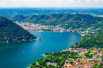 High angle view of city by sea against sky