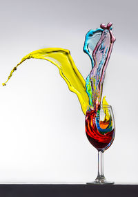 Close-up of red wine against white background