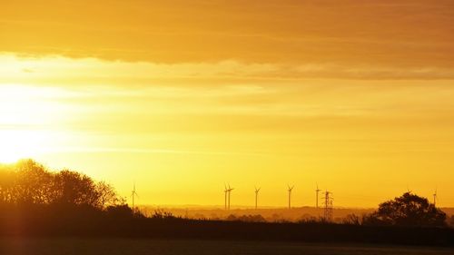 Scenic view of field against sky during sunset