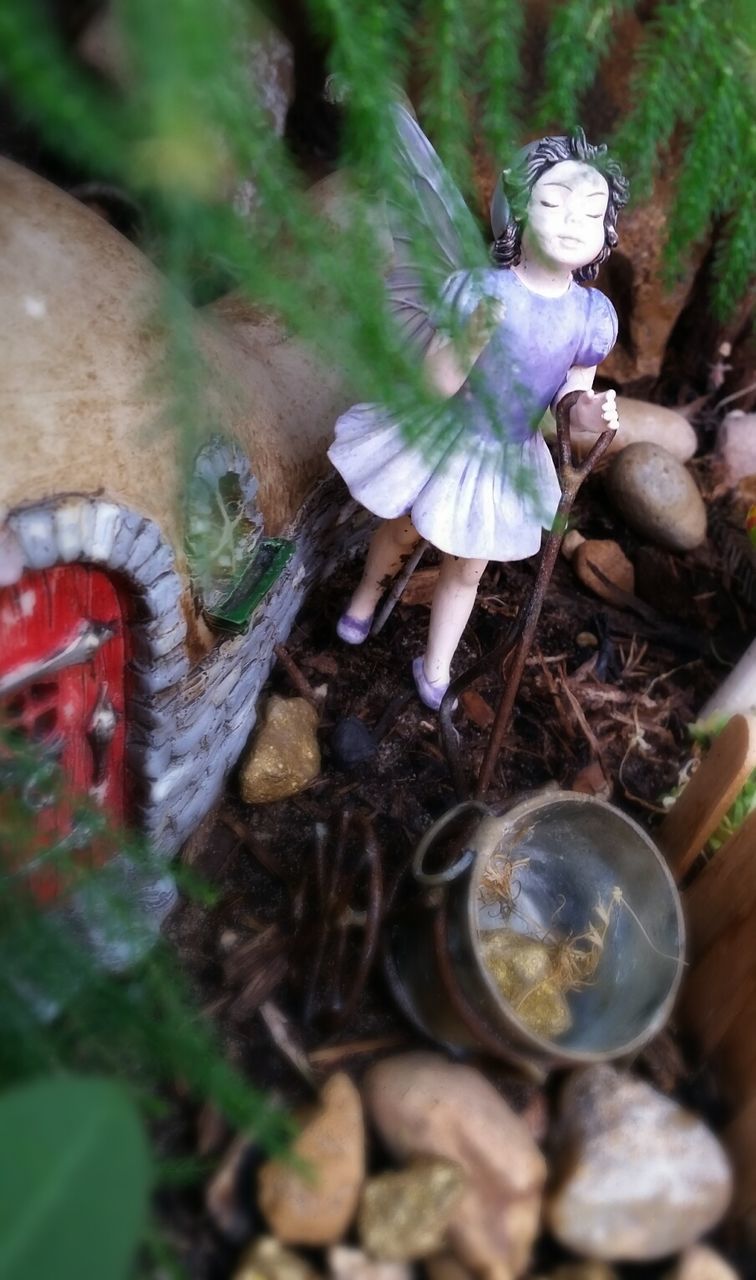close-up, selective focus, focus on foreground, field, day, no people, outdoors, art and craft, messy, abandoned, creativity, plant, damaged, nature, obsolete, art, broken, high angle view, human representation, leaf