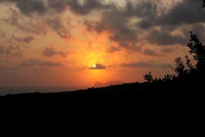 Scenic view of silhouette landscape against romantic sky at sunset