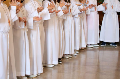 Low section of priests performing rituals in church