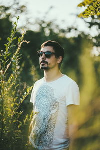 Young man wearing sunglasses standing outdoors