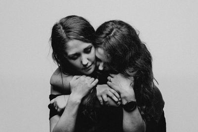  a mother and daugters loving deep unbreakable bond. daughter hugging her mother black and white