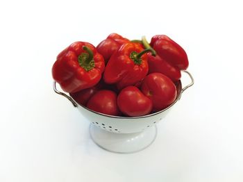 High angle view of tomatoes in bowl against white background