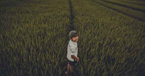 Rear view of boy on field