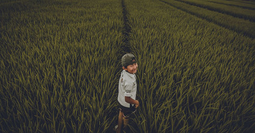 Rear view of boy on field