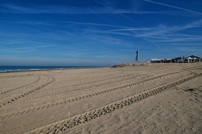 Scenic view of beach against blue sky