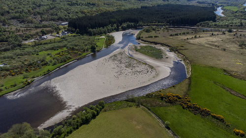 High angle view of river amidst green landscape