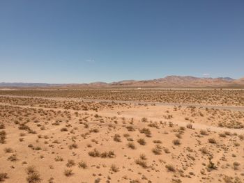 Scenic view of desert against clear sky