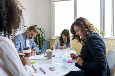 Multi-ethnic coworkers making strategy in office