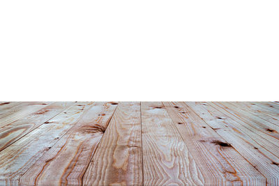 Close-up of wooden table against white background